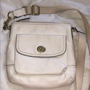Cream colored COACH cross body bag